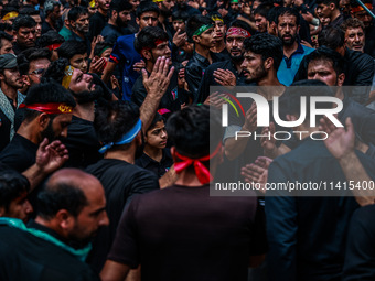 Kashmiri Shiite Muslims are chanting religious slogans as they take part in an Ashura procession during Muharram in Sopore, Jammu and Kashmi...