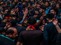 Kashmiri Shiite Muslims are chanting religious slogans as they take part in an Ashura procession during Muharram in Sopore, Jammu and Kashmi...