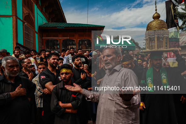 Kashmiri Shiite Muslims are chanting religious slogans as they take part in an Ashura procession during Muharram in Sopore, Jammu and Kashmi...