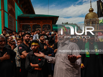 Kashmiri Shiite Muslims are chanting religious slogans as they take part in an Ashura procession during Muharram in Sopore, Jammu and Kashmi...