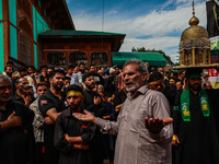 Kashmiri Shiite Muslims are chanting religious slogans as they take part in an Ashura procession during Muharram in Sopore, Jammu and Kashmi...