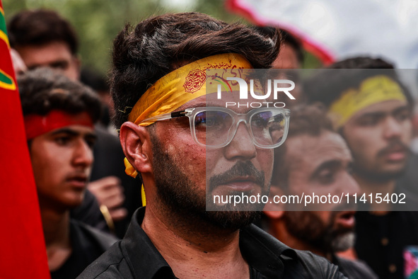 Kashmiri Shiite Muslims are chanting religious slogans as they take part in an Ashura procession during Muharram in Sopore, Jammu and Kashmi...