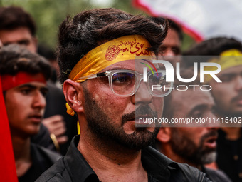 Kashmiri Shiite Muslims are chanting religious slogans as they take part in an Ashura procession during Muharram in Sopore, Jammu and Kashmi...