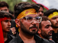 Kashmiri Shiite Muslims are chanting religious slogans as they take part in an Ashura procession during Muharram in Sopore, Jammu and Kashmi...