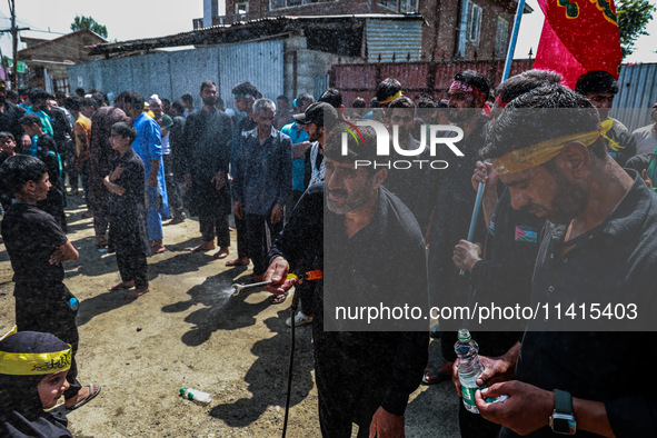 Kashmiri Shiite Muslims are chanting religious slogans as they take part in an Ashura procession during Muharram in Sopore, Jammu and Kashmi...