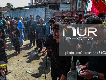 Kashmiri Shiite Muslims are chanting religious slogans as they take part in an Ashura procession during Muharram in Sopore, Jammu and Kashmi...