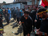 Kashmiri Shiite Muslims are chanting religious slogans as they take part in an Ashura procession during Muharram in Sopore, Jammu and Kashmi...