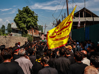 Kashmiri Shiite Muslims are chanting religious slogans as they take part in an Ashura procession during Muharram in Sopore, Jammu and Kashmi...