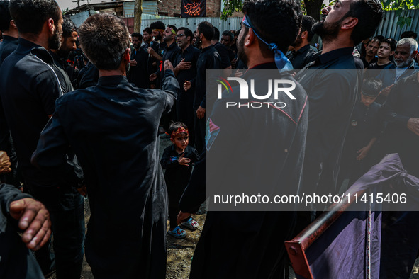 Kashmiri Shiite Muslims are chanting religious slogans as they take part in an Ashura procession during Muharram in Sopore, Jammu and Kashmi...