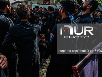 Kashmiri Shiite Muslims are chanting religious slogans as they take part in an Ashura procession during Muharram in Sopore, Jammu and Kashmi...