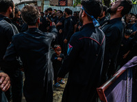 Kashmiri Shiite Muslims are chanting religious slogans as they take part in an Ashura procession during Muharram in Sopore, Jammu and Kashmi...