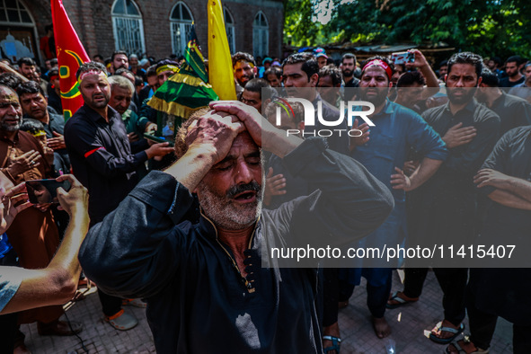 Kashmiri Shiite Muslims are chanting religious slogans as they take part in an Ashura procession during Muharram in Sopore, Jammu and Kashmi...