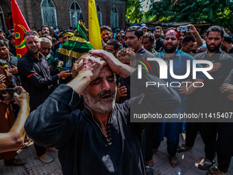 Kashmiri Shiite Muslims are chanting religious slogans as they take part in an Ashura procession during Muharram in Sopore, Jammu and Kashmi...