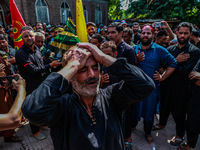 Kashmiri Shiite Muslims are chanting religious slogans as they take part in an Ashura procession during Muharram in Sopore, Jammu and Kashmi...