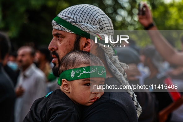 Kashmiri Shiite Muslims are chanting religious slogans as they take part in an Ashura procession during Muharram in Sopore, Jammu and Kashmi...