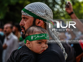 Kashmiri Shiite Muslims are chanting religious slogans as they take part in an Ashura procession during Muharram in Sopore, Jammu and Kashmi...