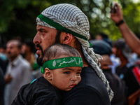 Kashmiri Shiite Muslims are chanting religious slogans as they take part in an Ashura procession during Muharram in Sopore, Jammu and Kashmi...