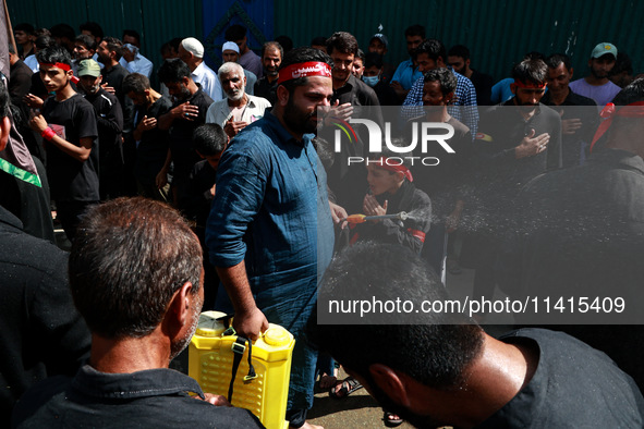 Kashmiri Shiite Muslims are chanting religious slogans as they take part in an Ashura procession during Muharram in Sopore, Jammu and Kashmi...