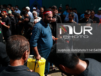 Kashmiri Shiite Muslims are chanting religious slogans as they take part in an Ashura procession during Muharram in Sopore, Jammu and Kashmi...