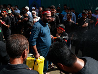 Kashmiri Shiite Muslims are chanting religious slogans as they take part in an Ashura procession during Muharram in Sopore, Jammu and Kashmi...