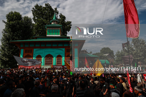 Kashmiri Shiite Muslims are chanting religious slogans as they take part in an Ashura procession during Muharram in Sopore, Jammu and Kashmi...