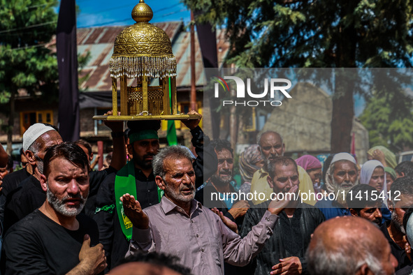 Kashmiri Shiite Muslims are chanting religious slogans as they take part in an Ashura procession during Muharram in Sopore, Jammu and Kashmi...