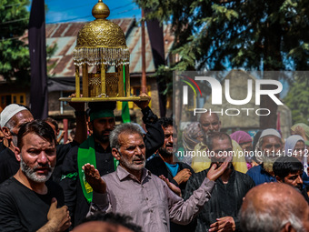 Kashmiri Shiite Muslims are chanting religious slogans as they take part in an Ashura procession during Muharram in Sopore, Jammu and Kashmi...