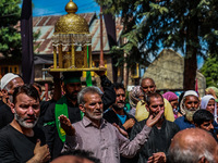 Kashmiri Shiite Muslims are chanting religious slogans as they take part in an Ashura procession during Muharram in Sopore, Jammu and Kashmi...