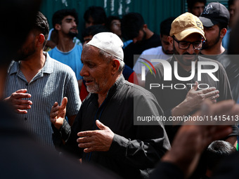 Kashmiri Shiite Muslims are chanting religious slogans as they take part in an Ashura procession during Muharram in Sopore, Jammu and Kashmi...