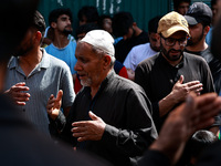 Kashmiri Shiite Muslims are chanting religious slogans as they take part in an Ashura procession during Muharram in Sopore, Jammu and Kashmi...