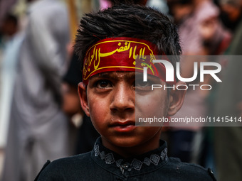 Kashmiri Shiite Muslims are chanting religious slogans as they take part in an Ashura procession during Muharram in Sopore, Jammu and Kashmi...