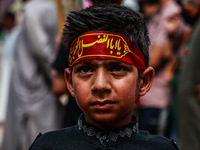 Kashmiri Shiite Muslims are chanting religious slogans as they take part in an Ashura procession during Muharram in Sopore, Jammu and Kashmi...