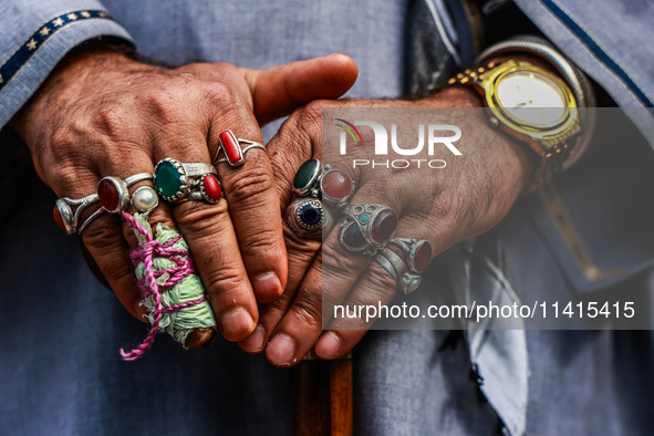 A Muslim man is wearing many rings as Kashmiri Shiite Muslims are chanting religious slogans while taking part in an Ashura procession durin...