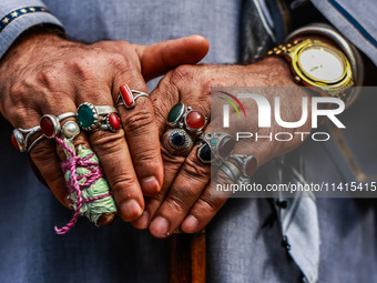 A Muslim man is wearing many rings as Kashmiri Shiite Muslims are chanting religious slogans while taking part in an Ashura procession durin...