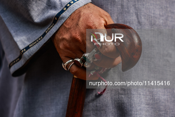 A Muslim man is wearing many rings as Kashmiri Shiite Muslims are chanting religious slogans while taking part in an Ashura procession durin...