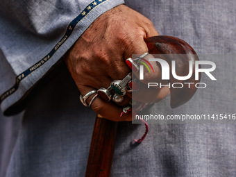 A Muslim man is wearing many rings as Kashmiri Shiite Muslims are chanting religious slogans while taking part in an Ashura procession durin...