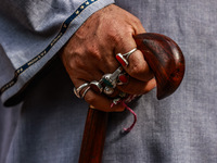 A Muslim man is wearing many rings as Kashmiri Shiite Muslims are chanting religious slogans while taking part in an Ashura procession durin...