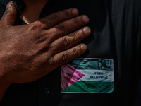 Shiite people are wearing Palestine flag stickers on their clothes while Muslims are chanting religious slogans as they take part in an Ashu...