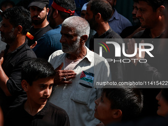 Shiite people are wearing Palestine flag stickers on their clothes while Muslims are chanting religious slogans as they take part in an Ashu...