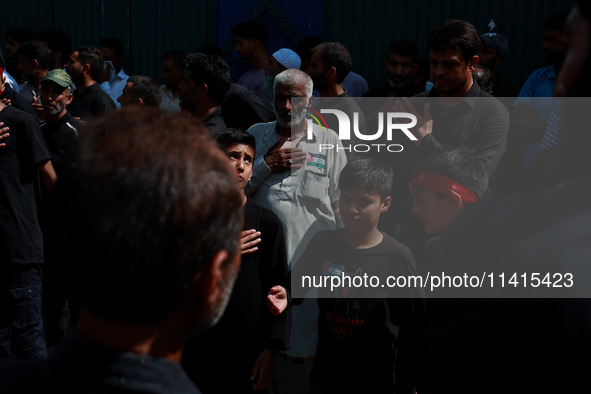 Shiite people are wearing Palestine flag stickers on their clothes while Muslims are chanting religious slogans as they take part in an Ashu...