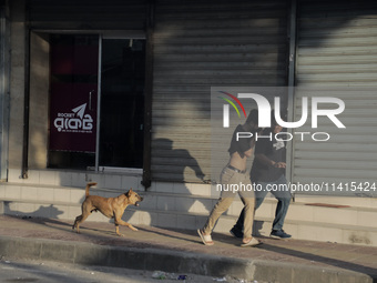 Pedestrians are fleeing as police are firing tear gas towards anti-quota protestors in Dhaka, Bangladesh, on July 17, 2024. (