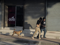 Pedestrians are fleeing as police are firing tear gas towards anti-quota protestors in Dhaka, Bangladesh, on July 17, 2024. (