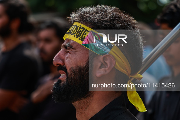 Shiite people are wearing Palestine flag stickers on their clothes while Muslims are chanting religious slogans as they take part in an Ashu...