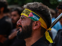 Shiite people are wearing Palestine flag stickers on their clothes while Muslims are chanting religious slogans as they take part in an Ashu...