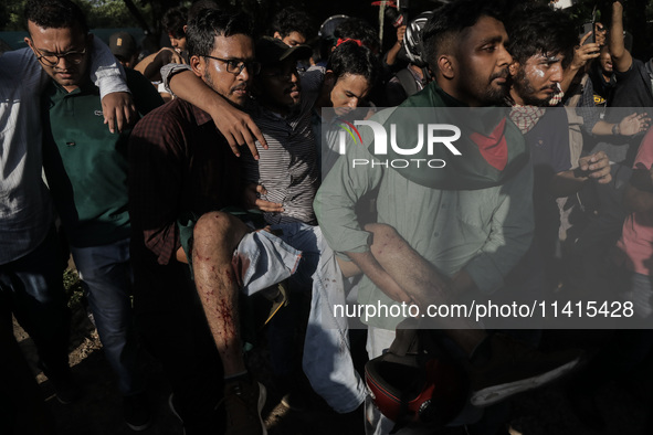 An anti-quota protestor is being rushed to the hospital after being shot by police during a clash in Dhaka, Bangladesh, on July 17, 2024. 