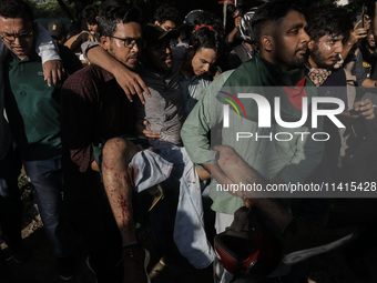 An anti-quota protestor is being rushed to the hospital after being shot by police during a clash in Dhaka, Bangladesh, on July 17, 2024. (