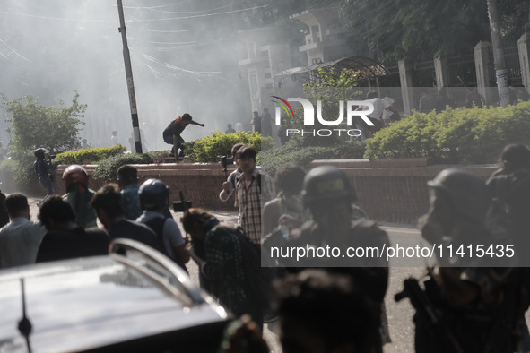 Anti-quota protestors are fleeing as police are firing tear gas and bullets towards them while approaching for a rally in Dhaka, Bangladesh,...