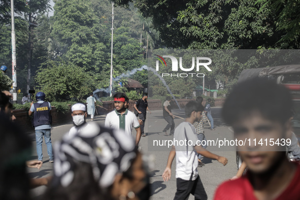 Anti-quota protestors are fleeing as police are firing tear gas and bullets towards them while approaching for a rally in Dhaka, Bangladesh,...