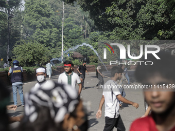 Anti-quota protestors are fleeing as police are firing tear gas and bullets towards them while approaching for a rally in Dhaka, Bangladesh,...