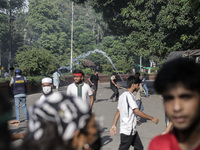 Anti-quota protestors are fleeing as police are firing tear gas and bullets towards them while approaching for a rally in Dhaka, Bangladesh,...